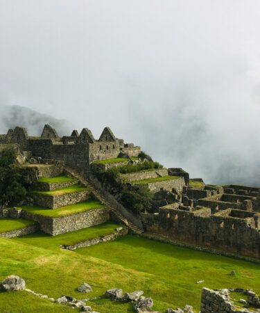 Views of Machu Picchu green fields and ancient building